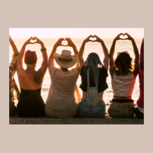 girls holding up hand hearts on beach girls holding up hand hearts on beach