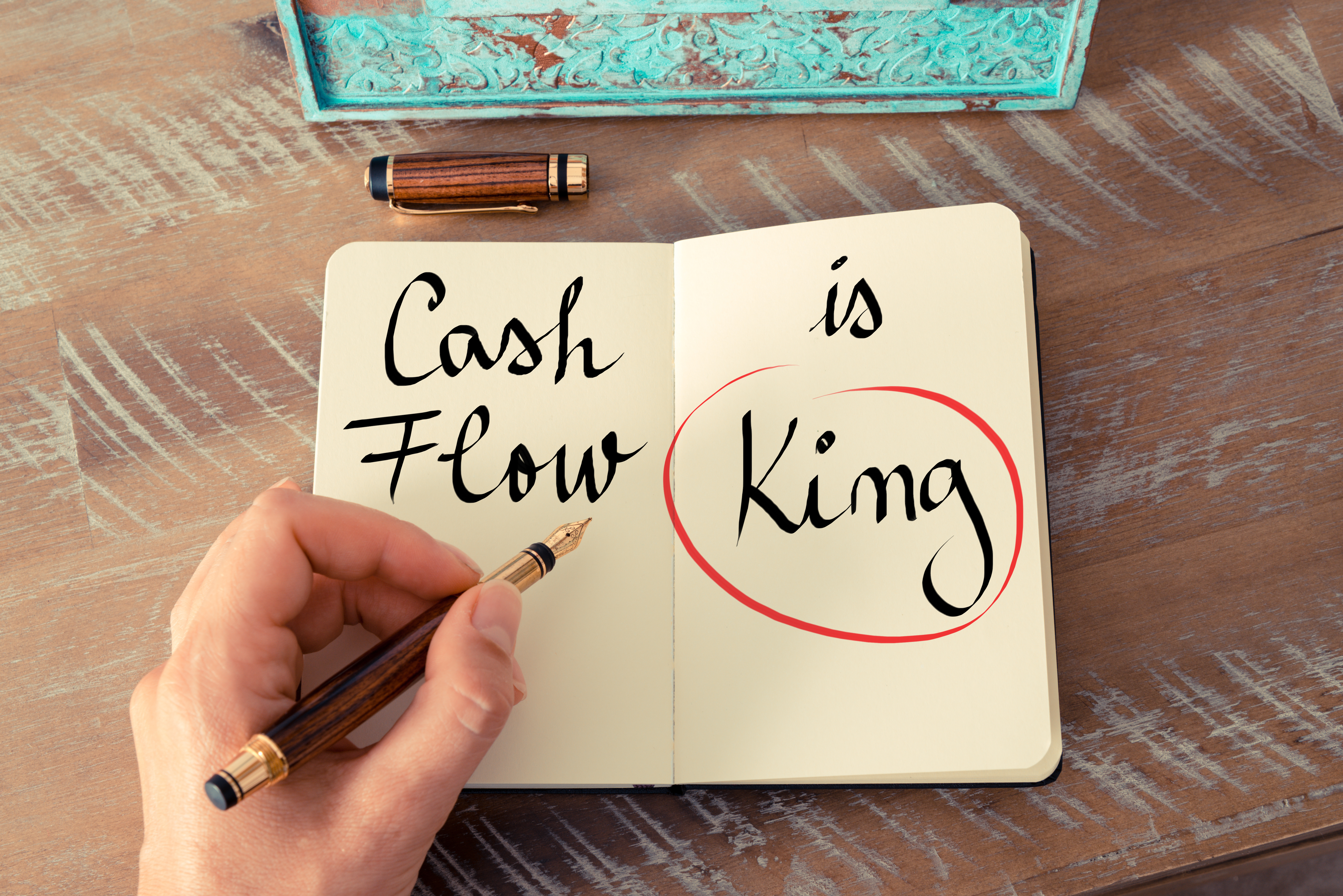 open journal with words cash flow is king