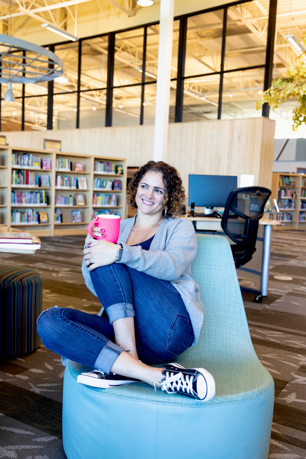 Entrepreneur finance coach holding a cup of coffee, seated in a chair, ready to provide expert guidance and support.