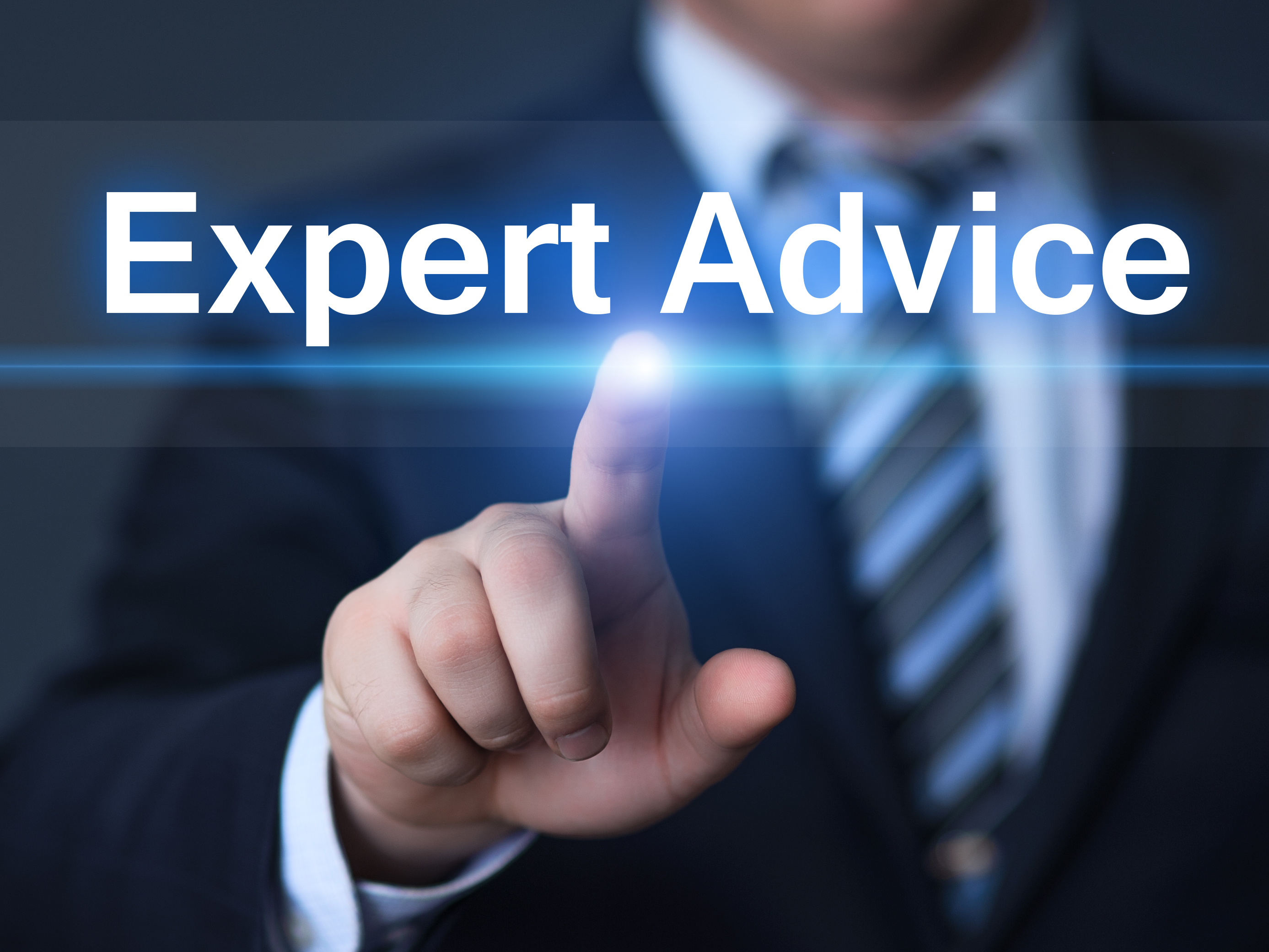 A man in a suit pointing like he is pushing a button that says Expert Advice
