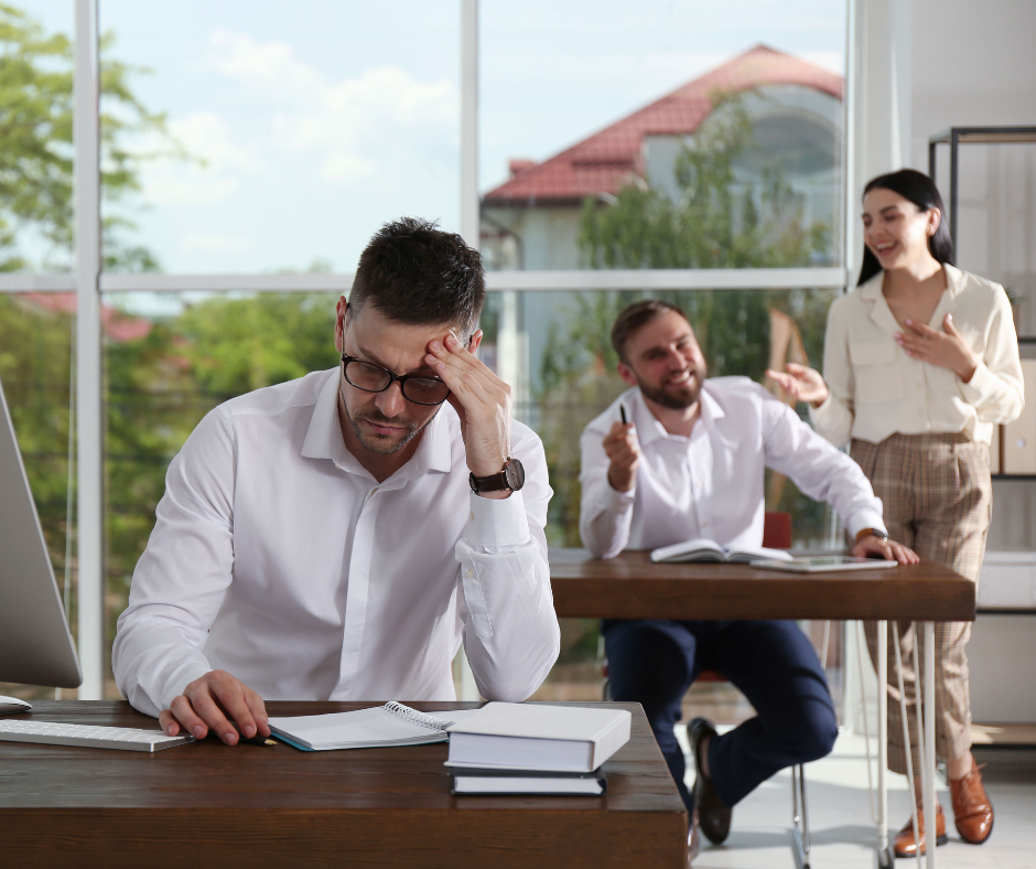 man getting laughed at at work