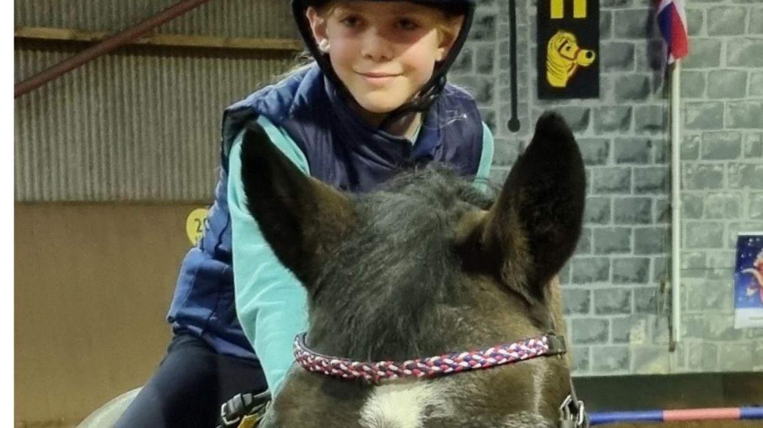 child riding horse