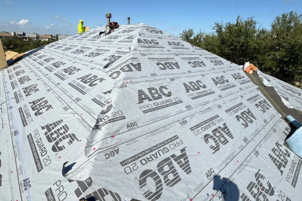 Residential roof under construction with ABC Pro Guard 20 synthetic roofing underlayment installed for superior waterproofing and durability, ensuring long-lasting protection before shingle installation.