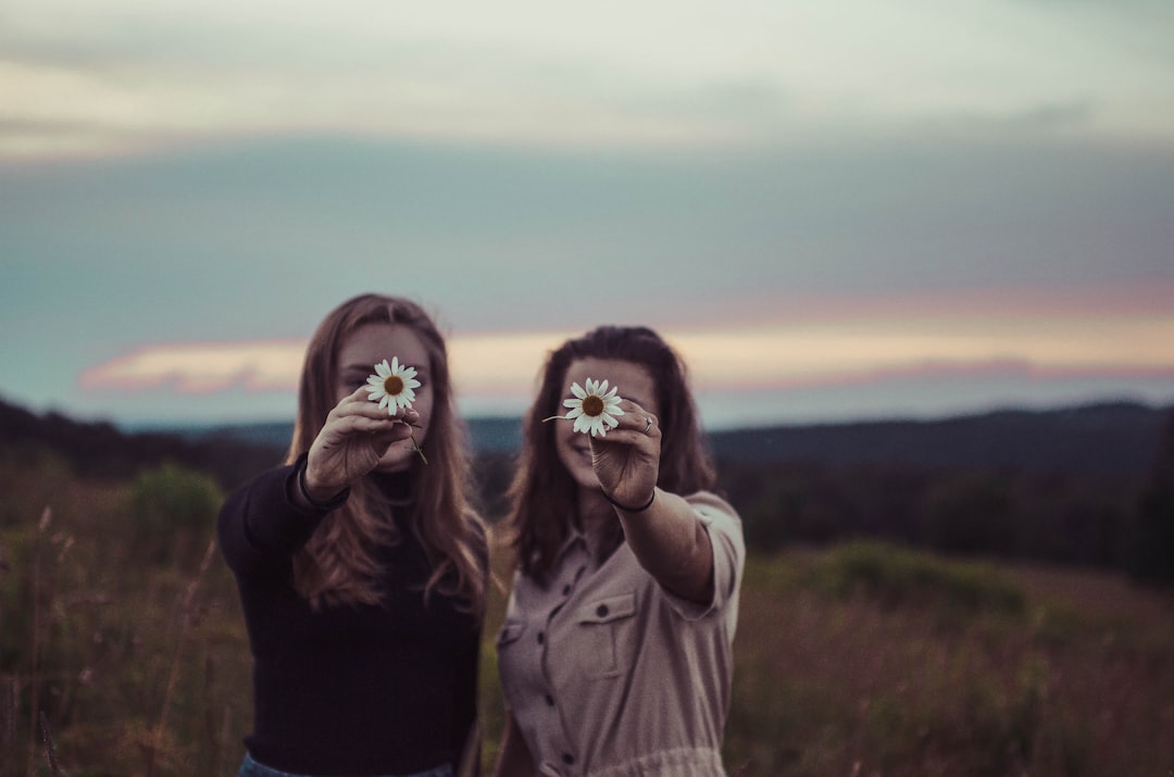 women holding flowers women holding flowers