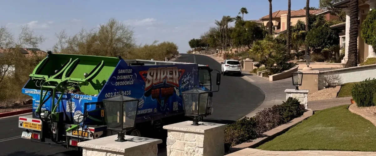 Super Bin Wash truck servicing homes in a suburban street. Super Bin Wash truck servicing homes in a suburban street.