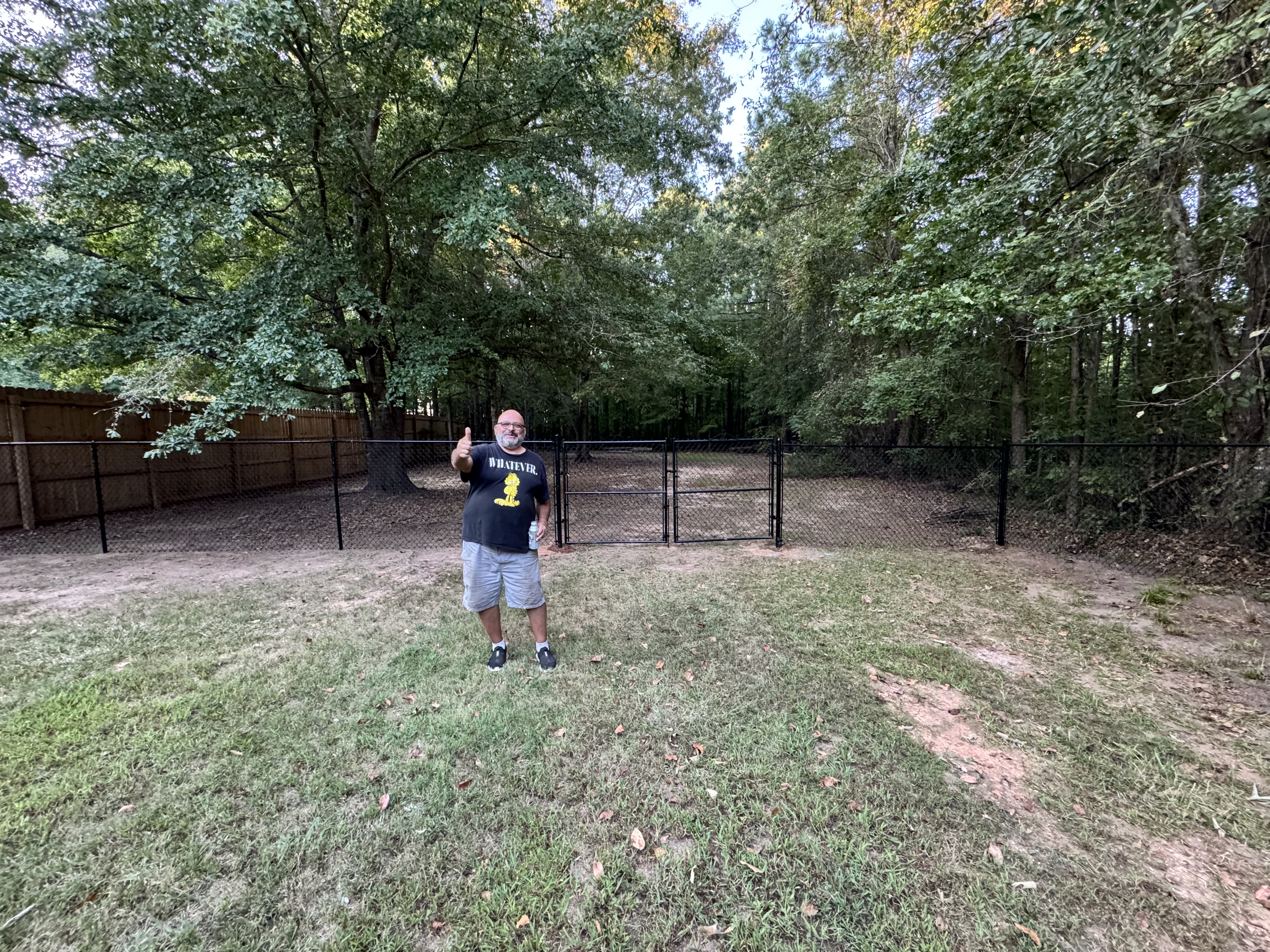 Happy customer standing by new fence