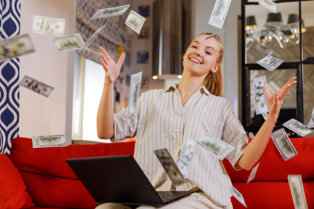 Lady on laptop with flying cash