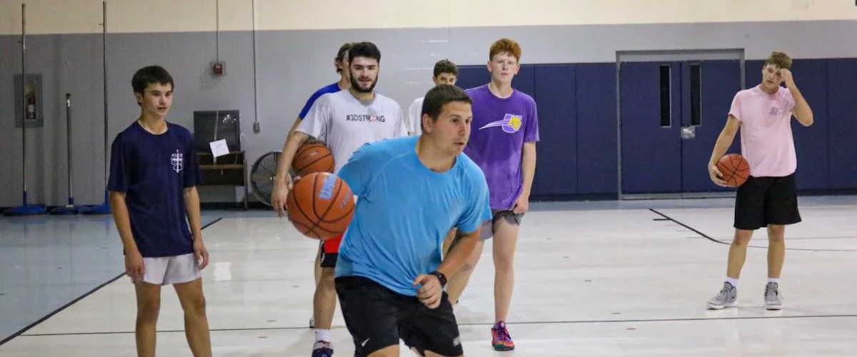 Youth basketball players practicing dribbling and teamwork indoors Youth basketball players practicing dribbling and teamwork indoors