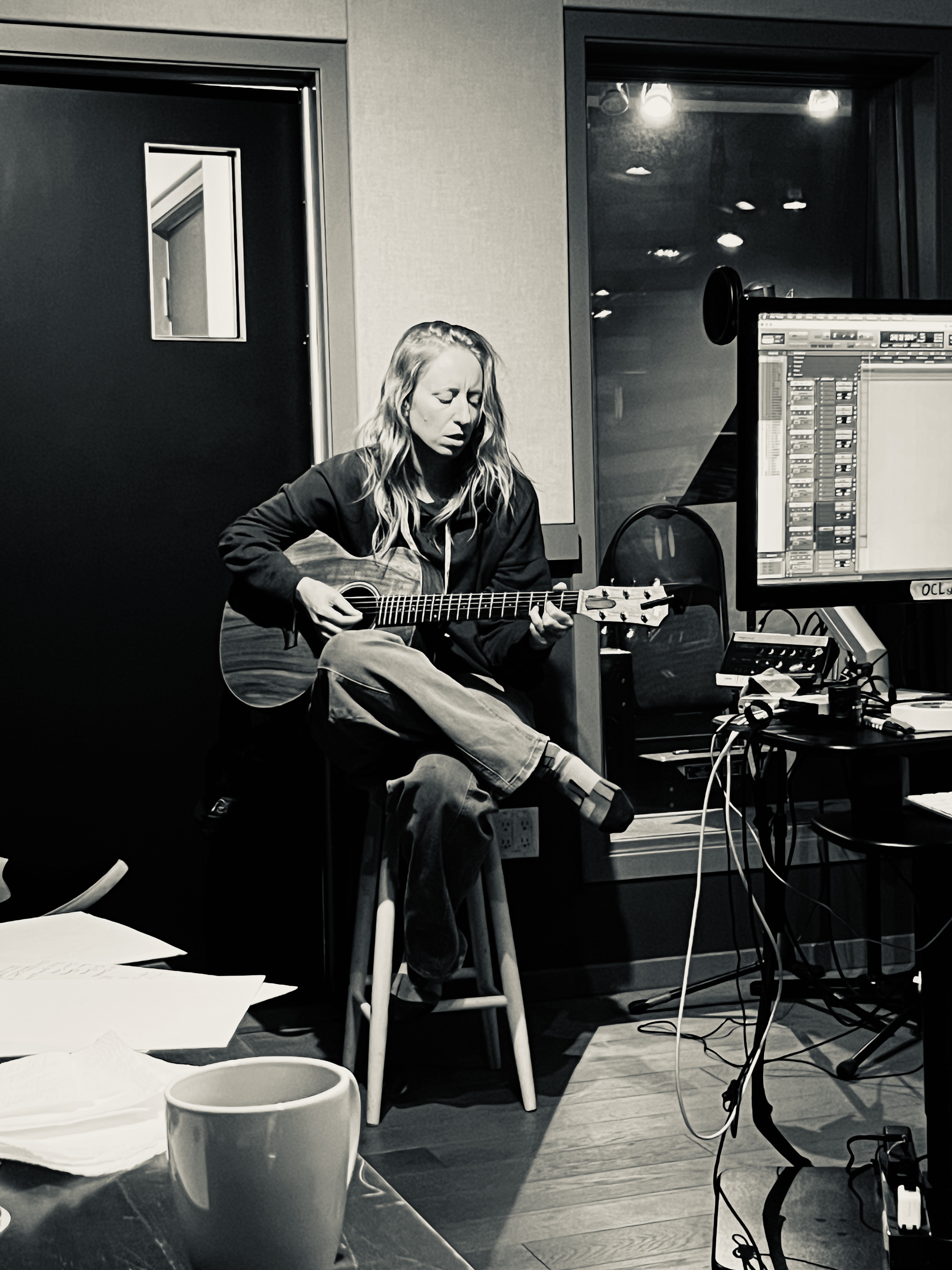 Jamie Wyman in studio playing guitar
