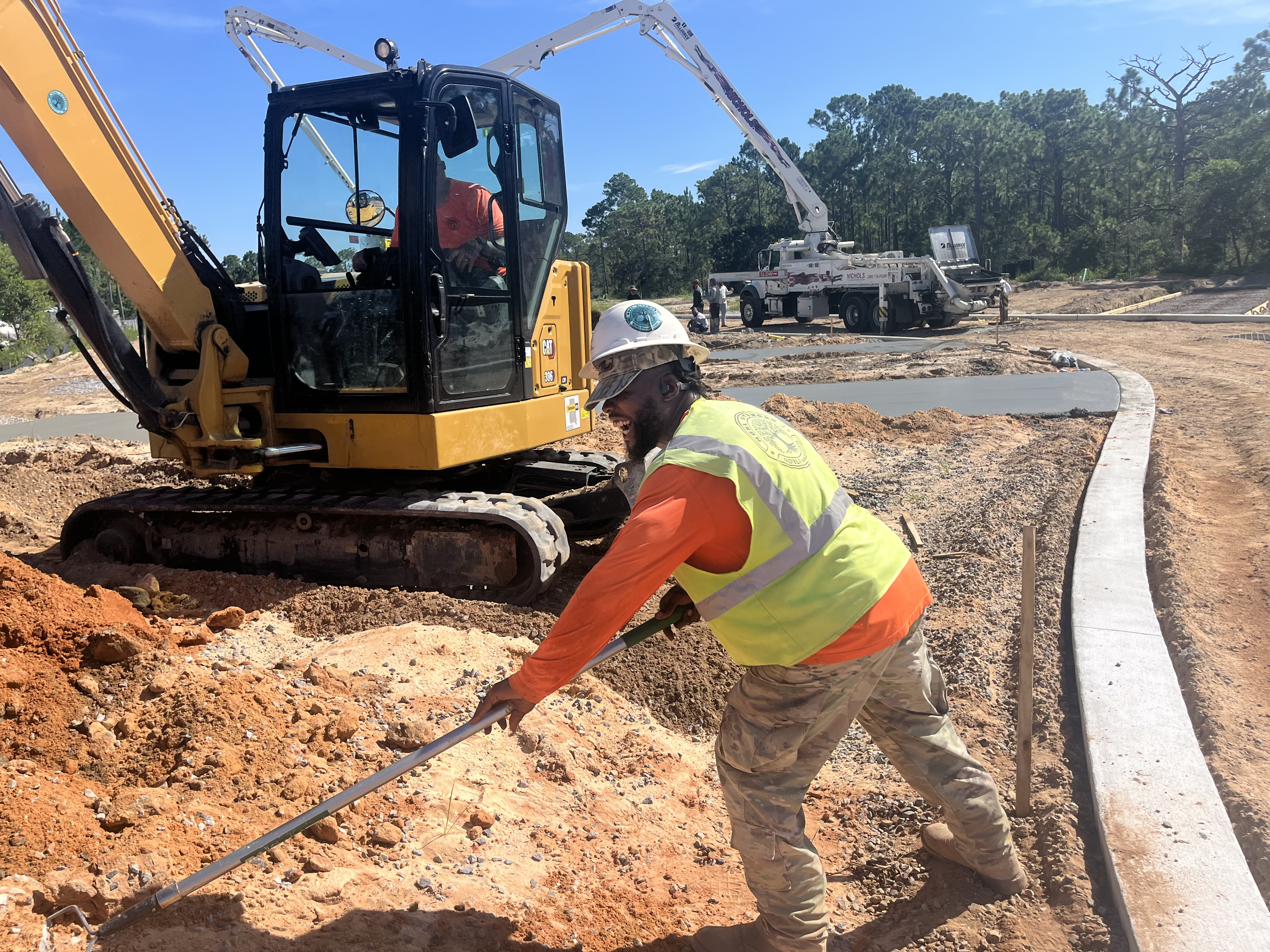 man in a trench with heavy equipment