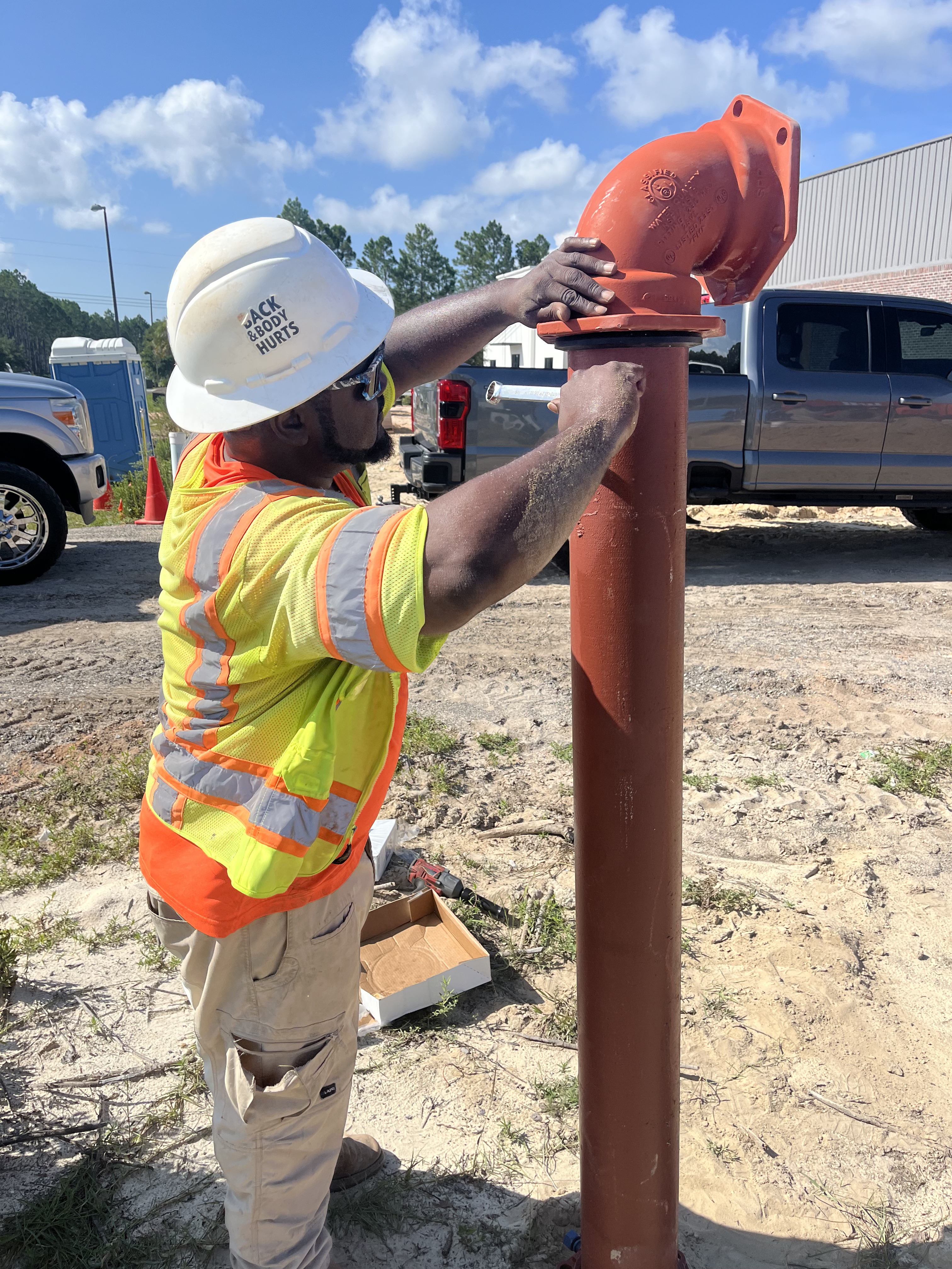 construction worker fixing pipe
