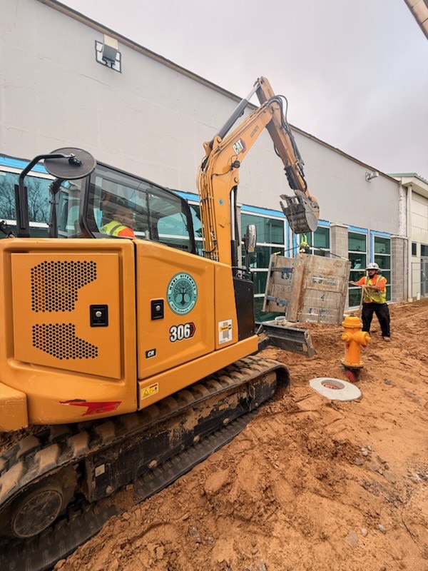 construction workers digging a hole construction workers digging a hole