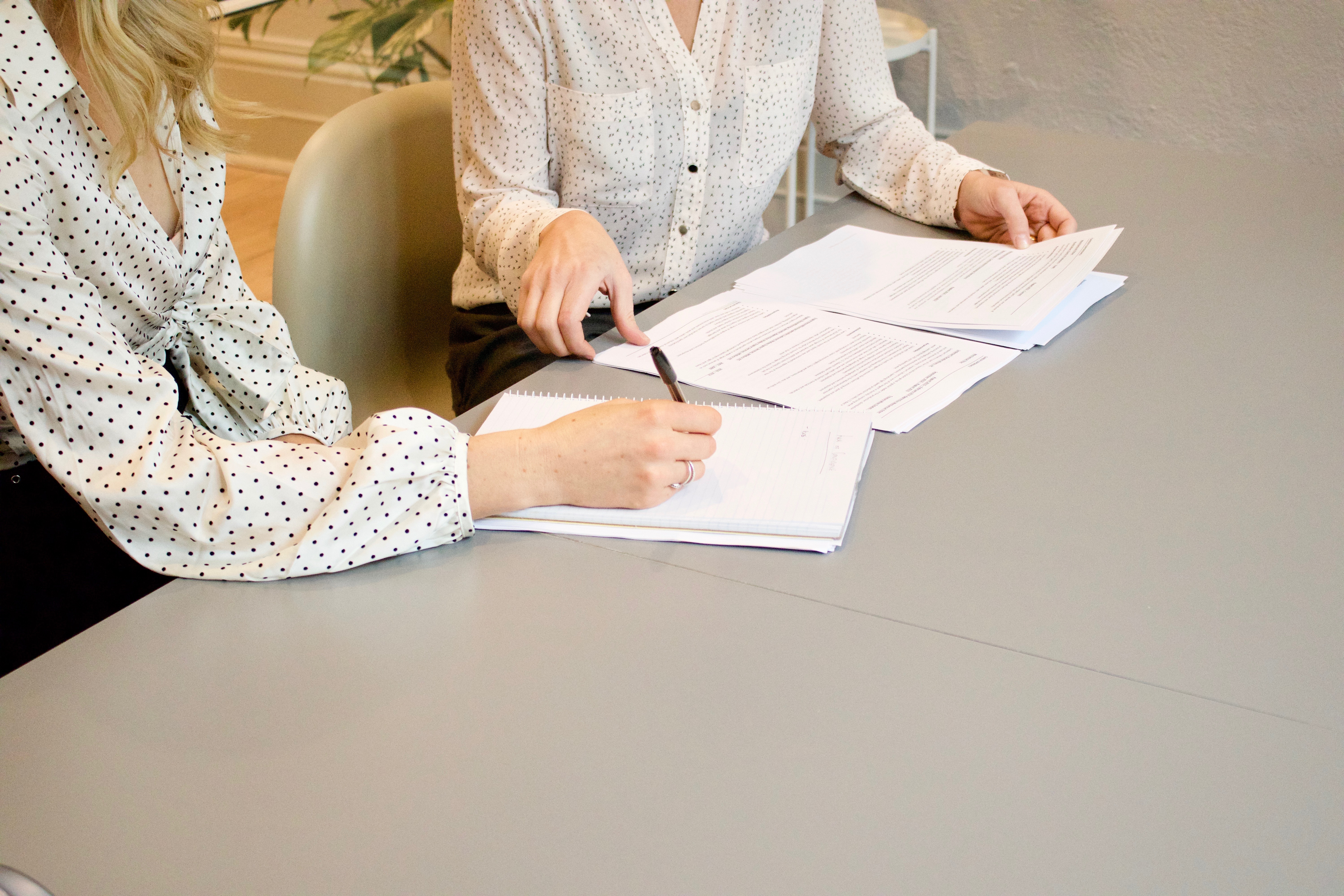 Photo of a woman signing a document