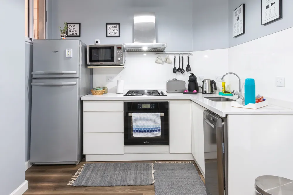 a kitchen with white cabinets and a table