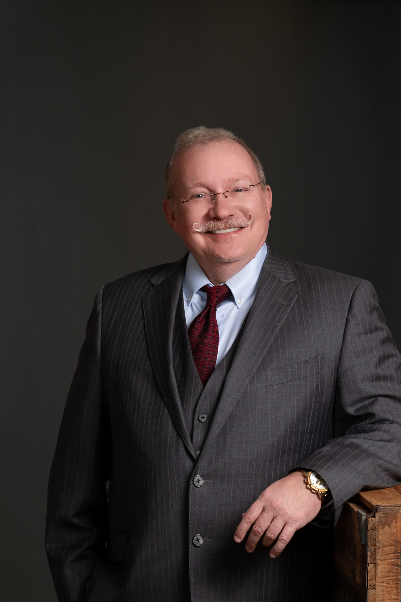Headshot of older man with handlebar mustache Headshot of older man with handlebar mustache