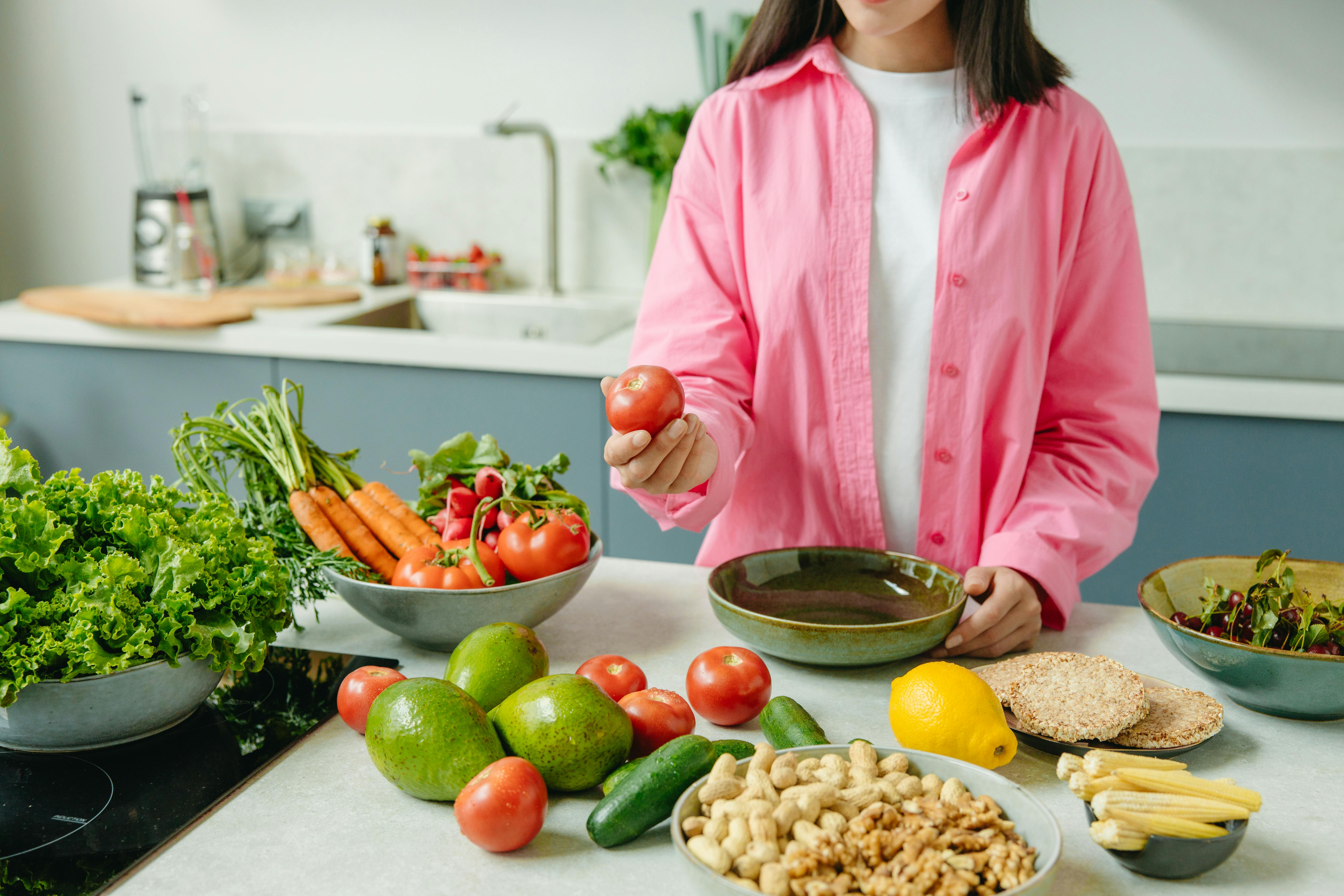 Woman Preparing Healthy Meal with Vegetables and Fruits Woman Preparing Healthy Meal with Vegetables and Fruits