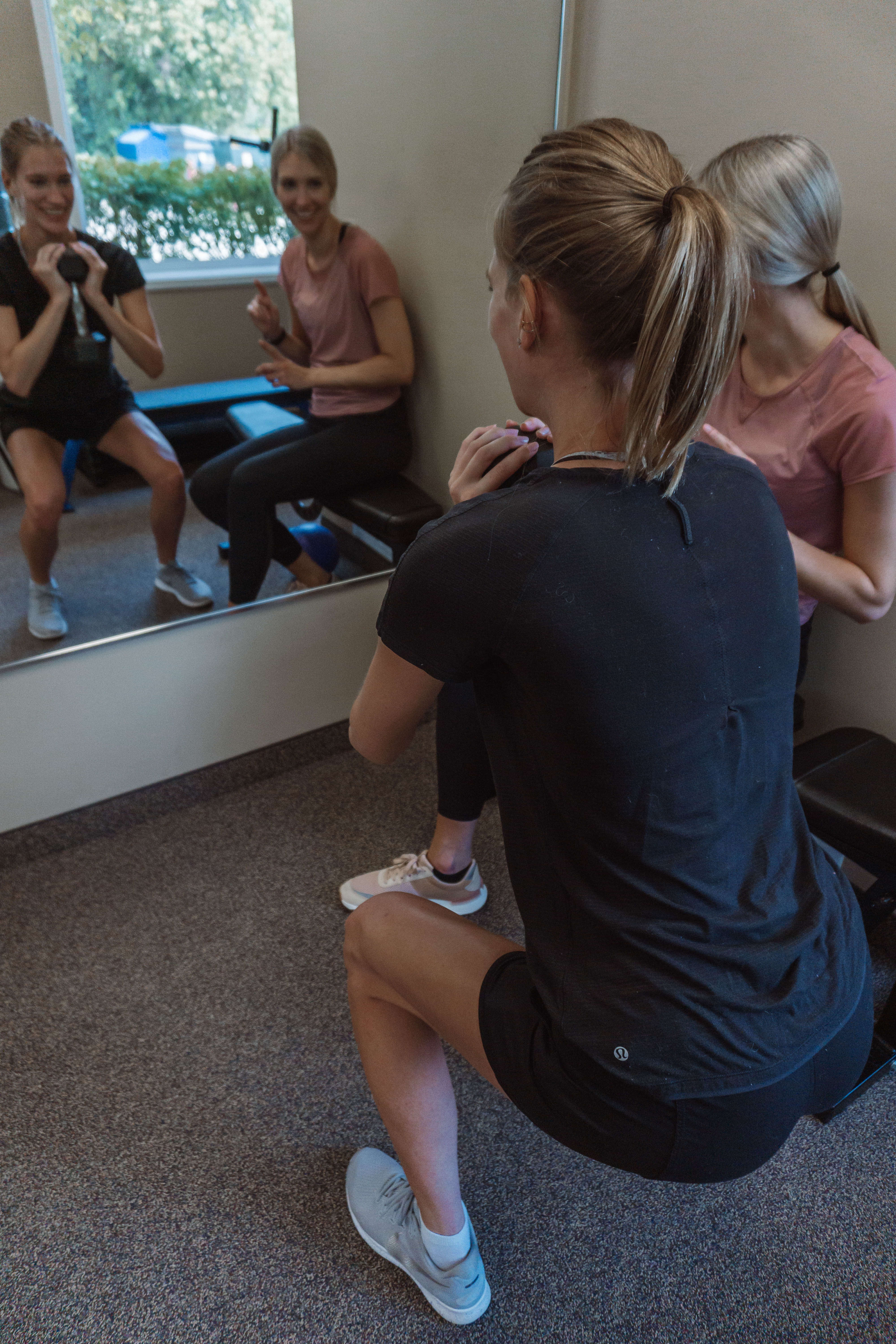Physiotherapist leading a female athlete through a strengthening program Physiotherapist leading a female athlete through a strengthening program