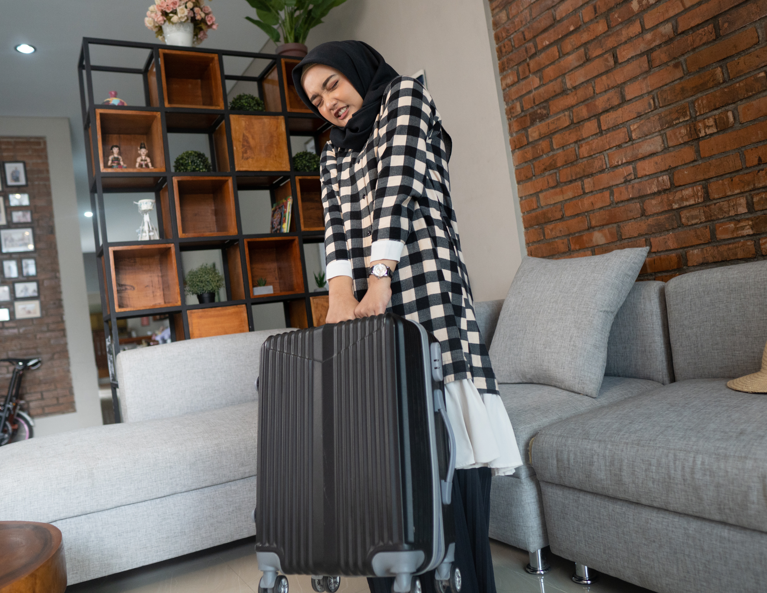 Woman struggling with luggage