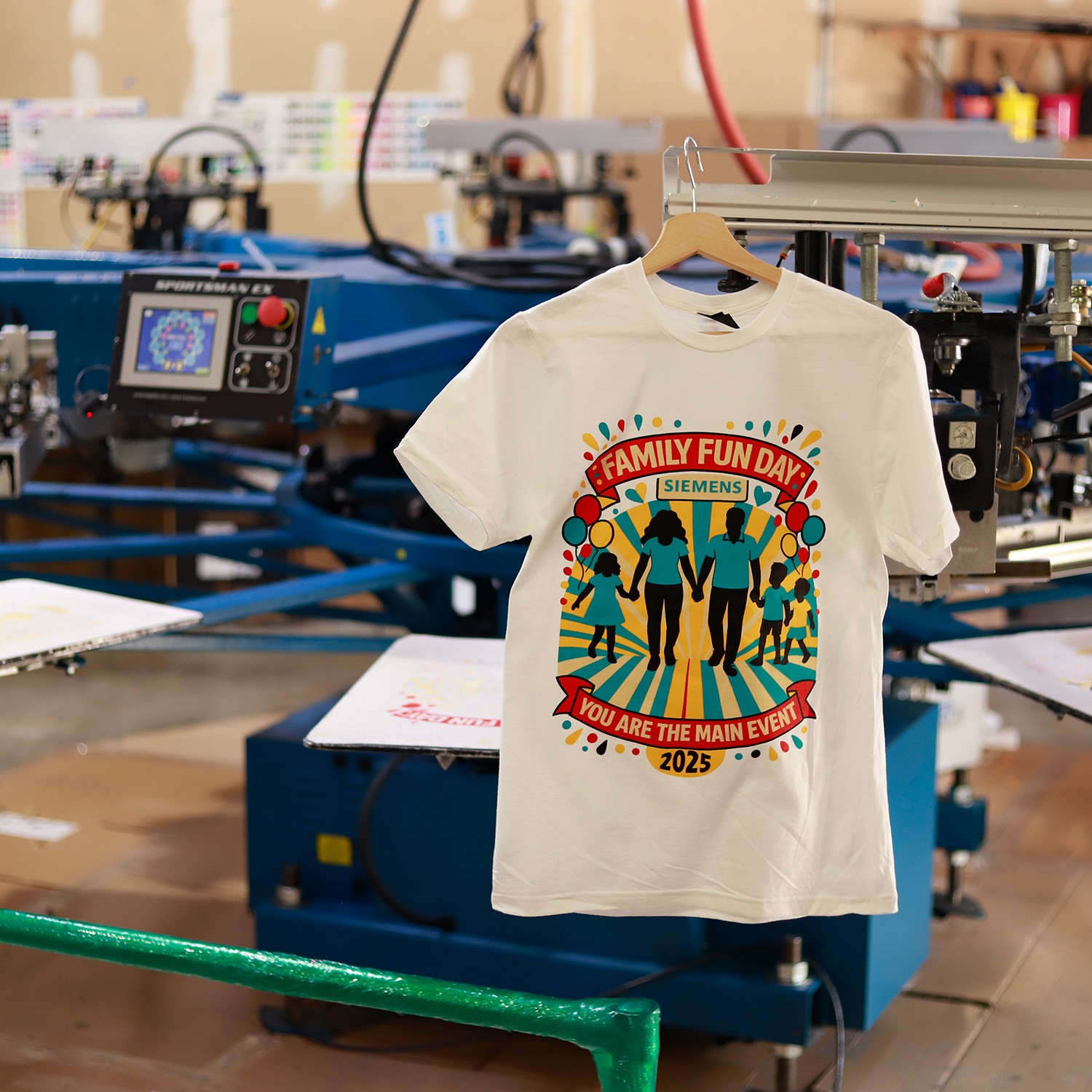 Getting Started with T-Shirt Screen Printing – Press in Action Hands using a squeegee to print a design on a T-shirt screen printing press