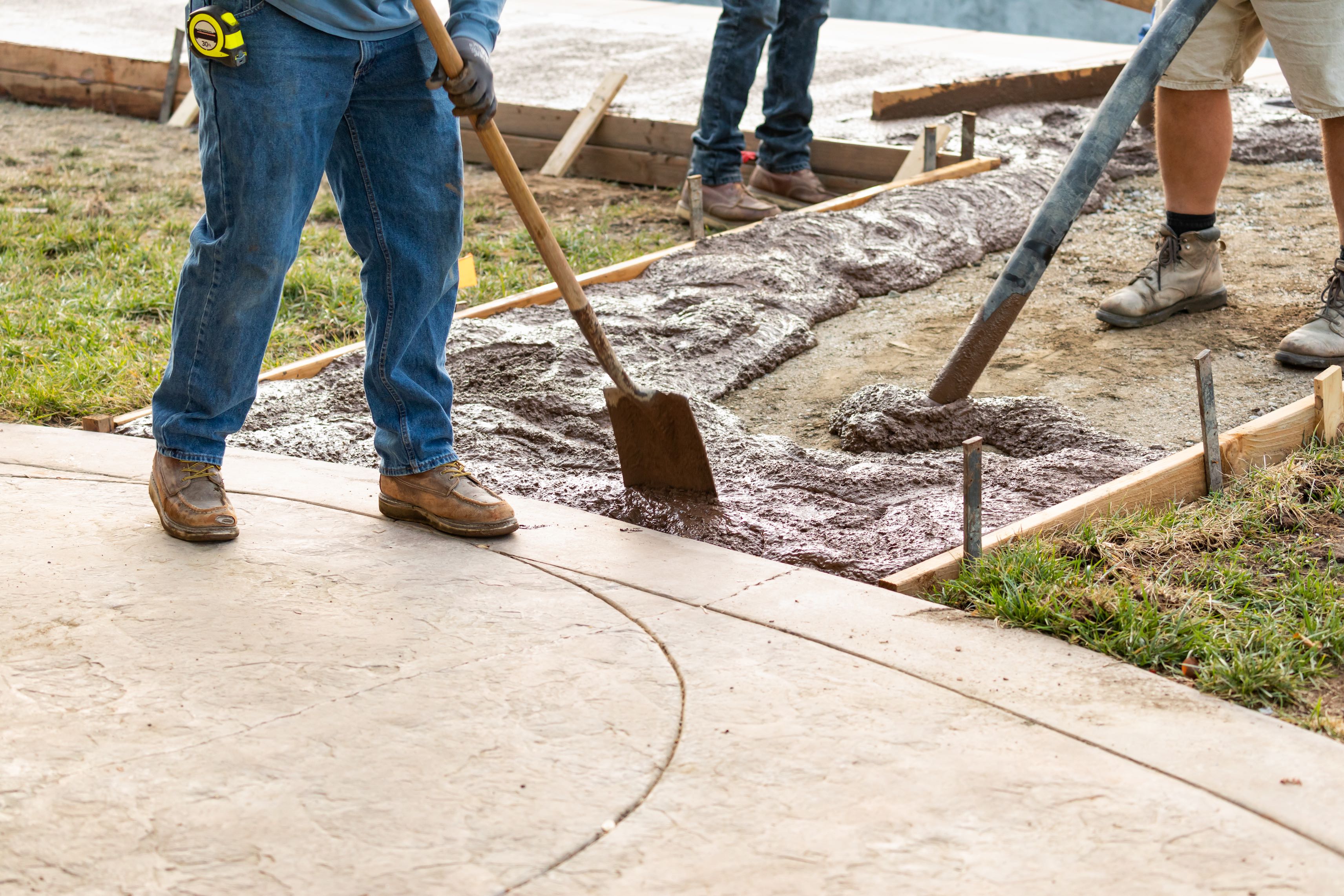 concrete contractor finishing stamped concrete walkway
