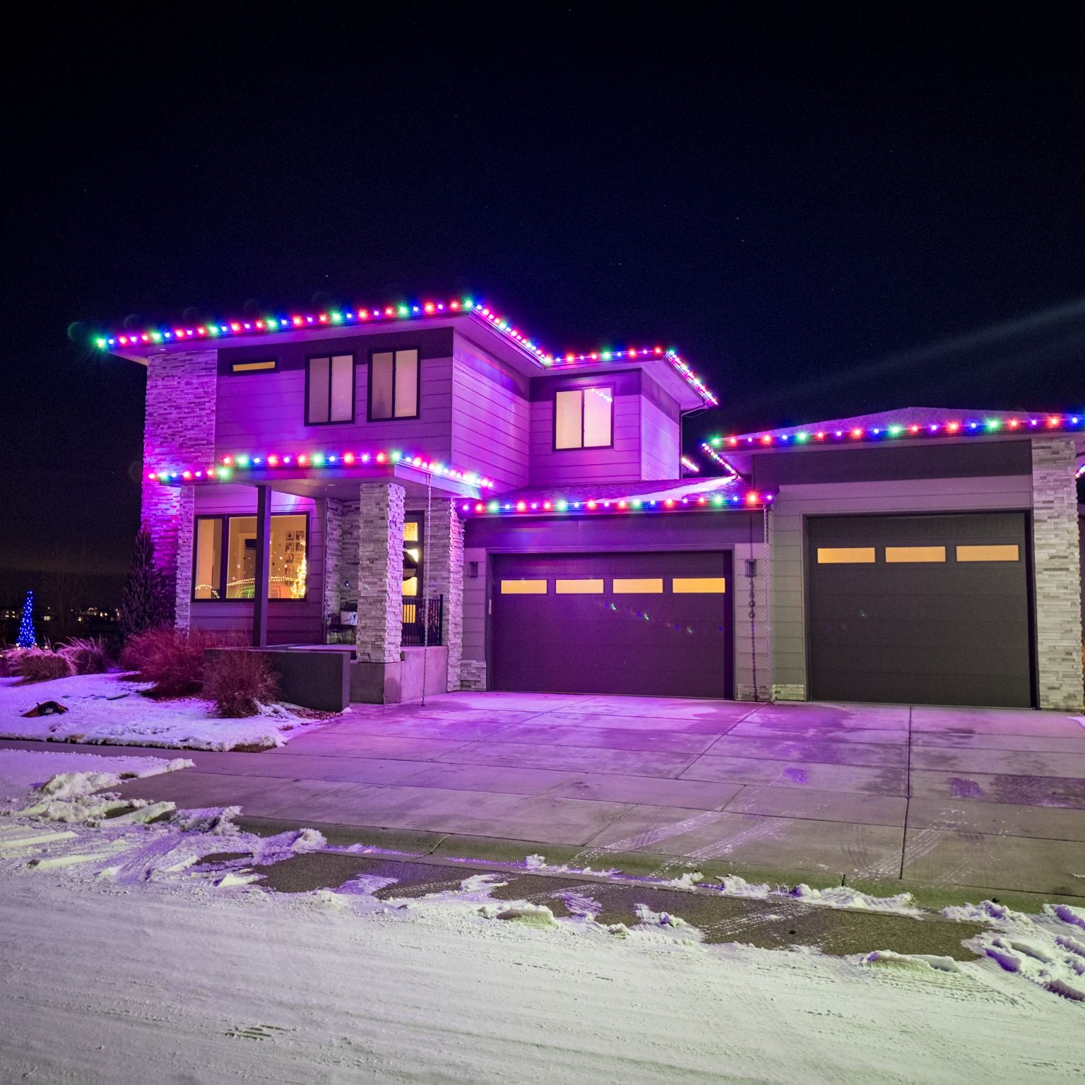Professional multi-color C9 Christmas light installation on a Timnath residence