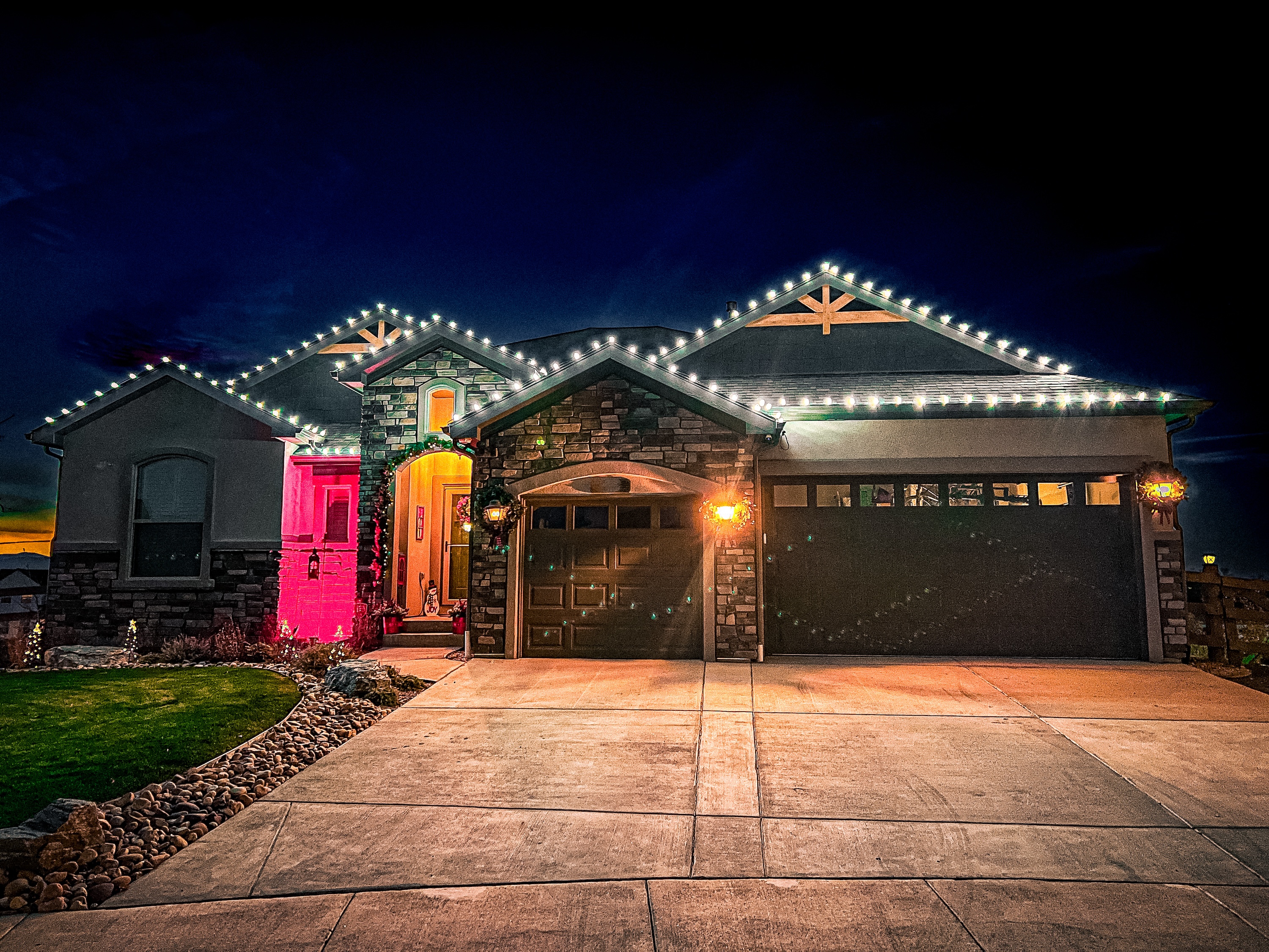 Bright cool white Christmas lights installation on Timnath home using commercial-grade C9 LED bulbs for modern holiday lighting