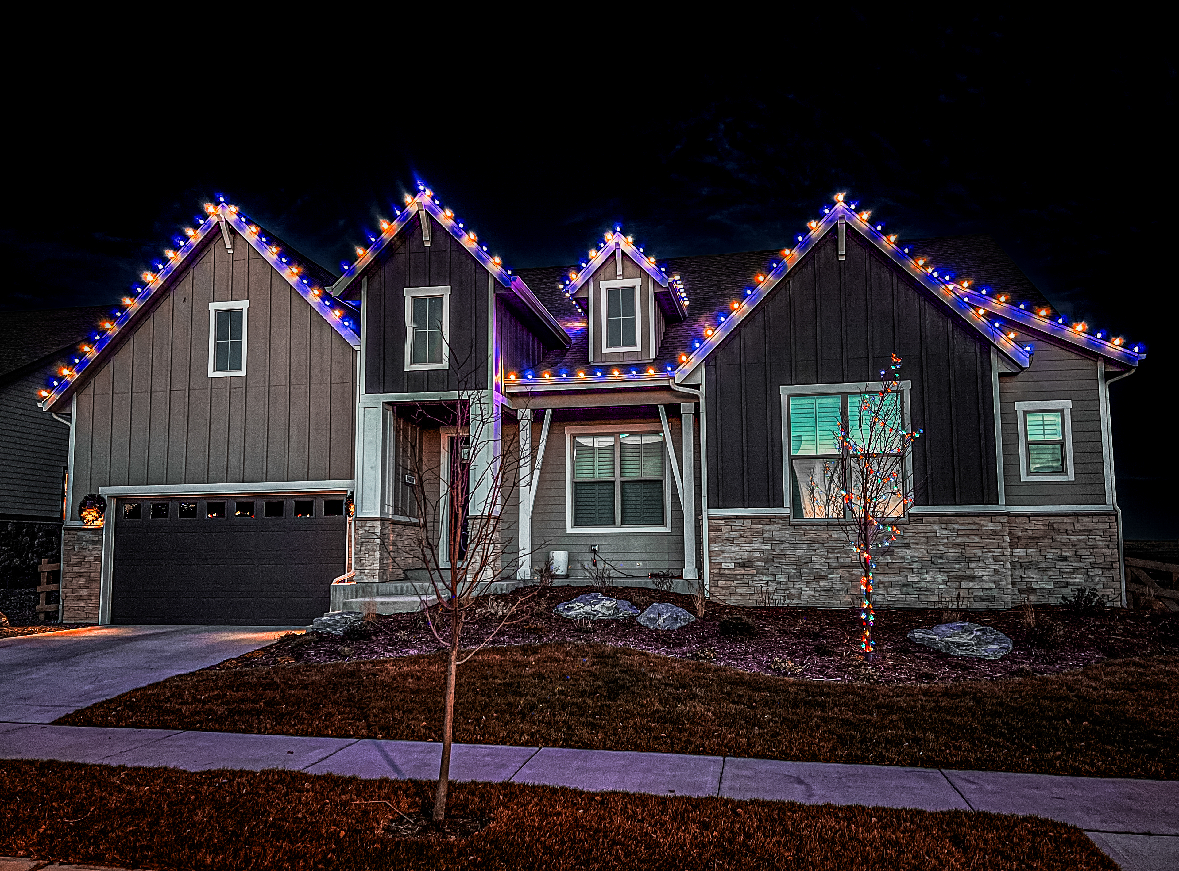 Warm white and blue Christmas light installation in Loveland using premium commercial-grade C9 bulbs for unique holiday home lighting