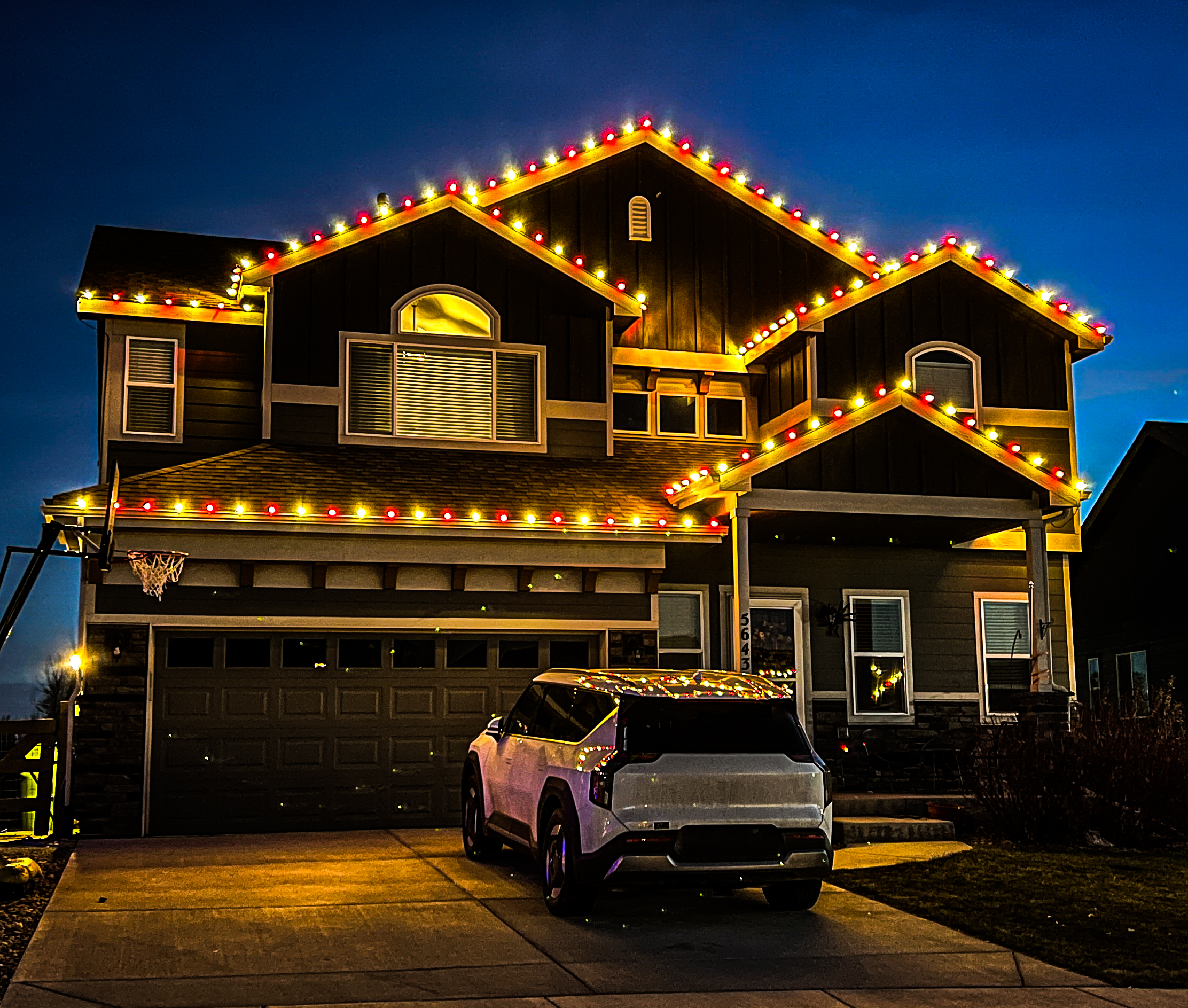 Traditional warm white and red C9 Christmas lights installation on Loveland home for classic holiday lighting