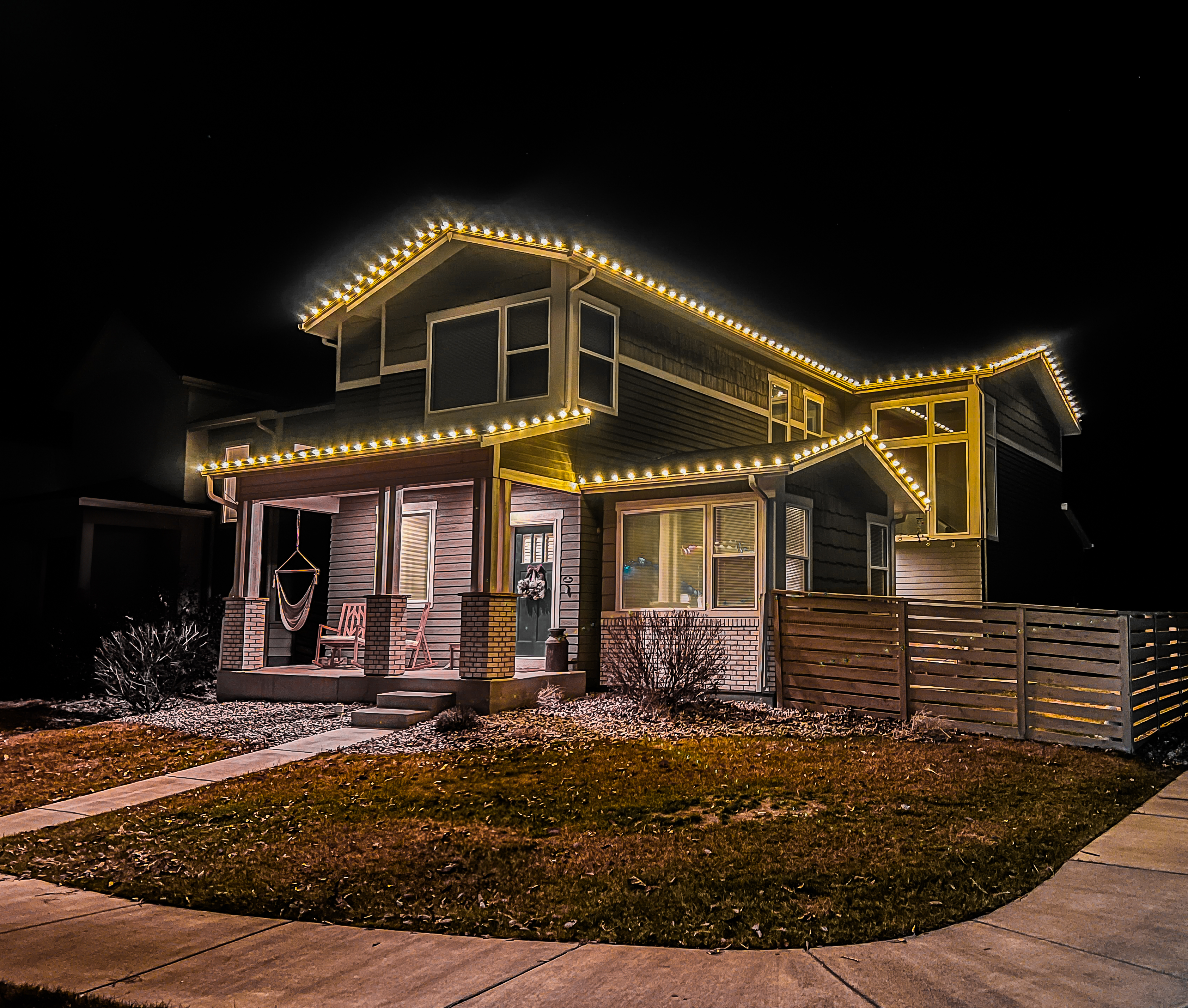 Warm white C9 Christmas lights professionally installed on a Loveland residence