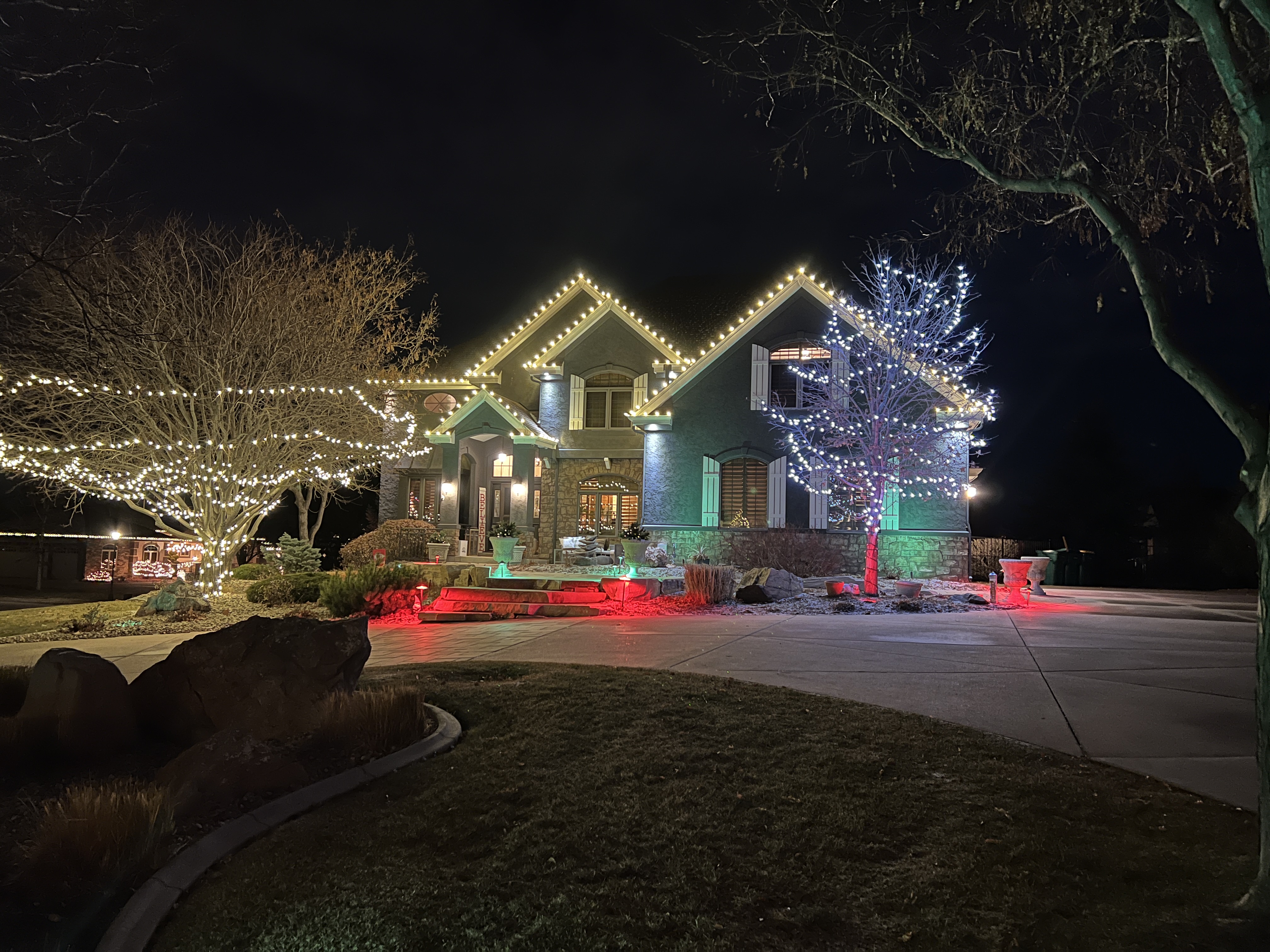 Cozy warm white roofline Christmas lights installed on a Greeley home