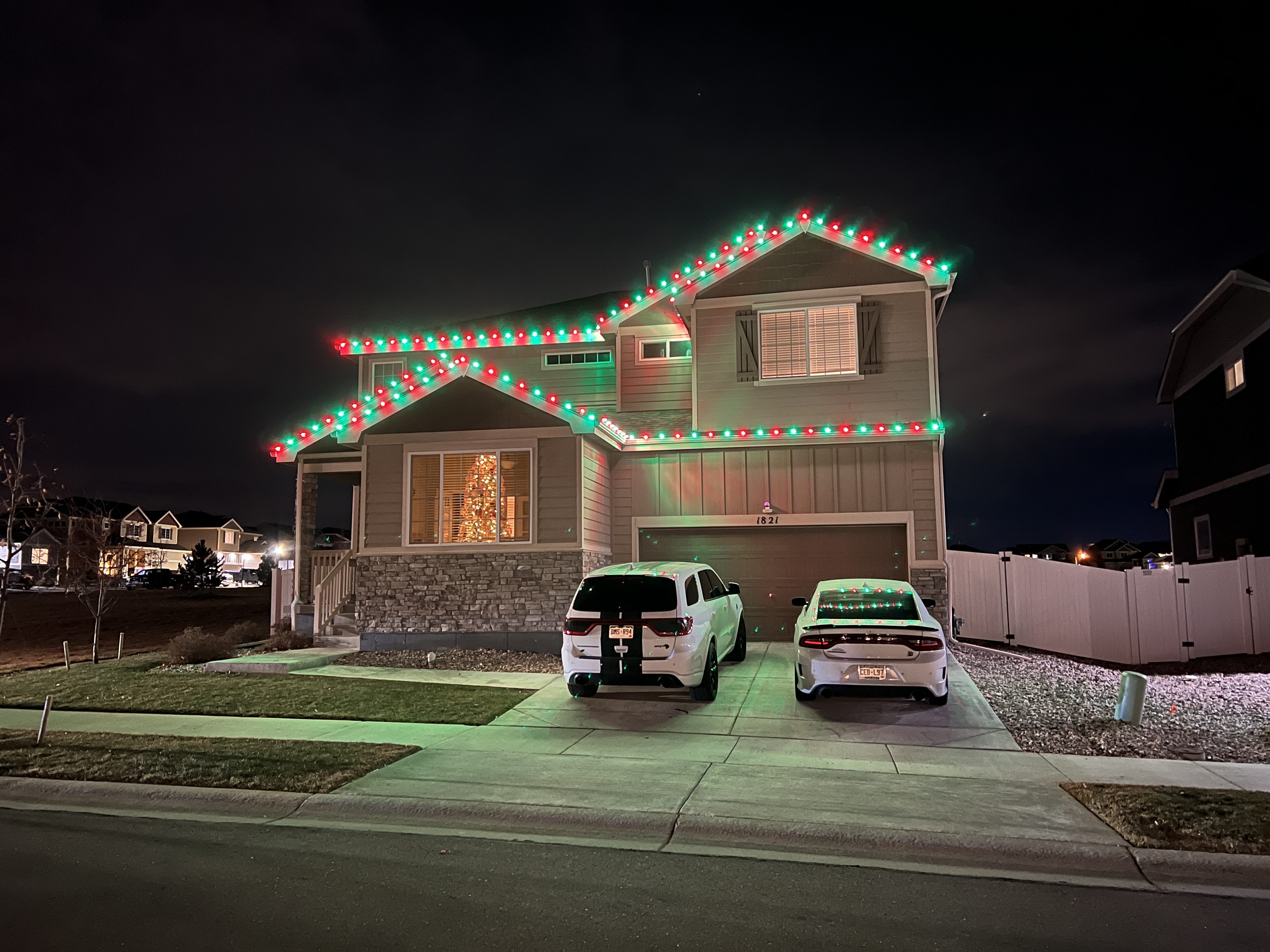 Festive green and red Christmas light installation in Greeley using premium commercial-grade C9 bulbs for traditional holiday home lighting