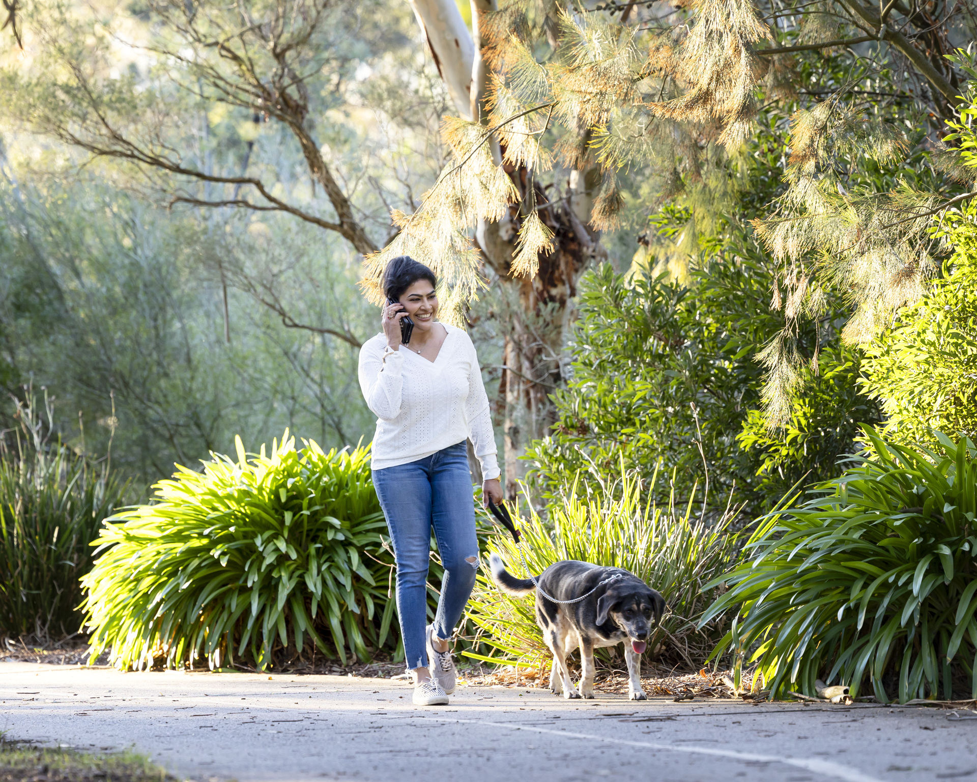 A lady walking her dog with green bushland in the background Alison McWhirter Personal Branding Photography Melbourne