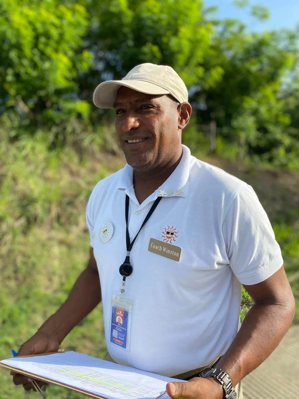 Local Dominican guide smiling and talking with travelers during an authentic Puerto Plata excursion. Local Dominican guide smiling and talking with travelers during an authentic Puerto Plata excursion.