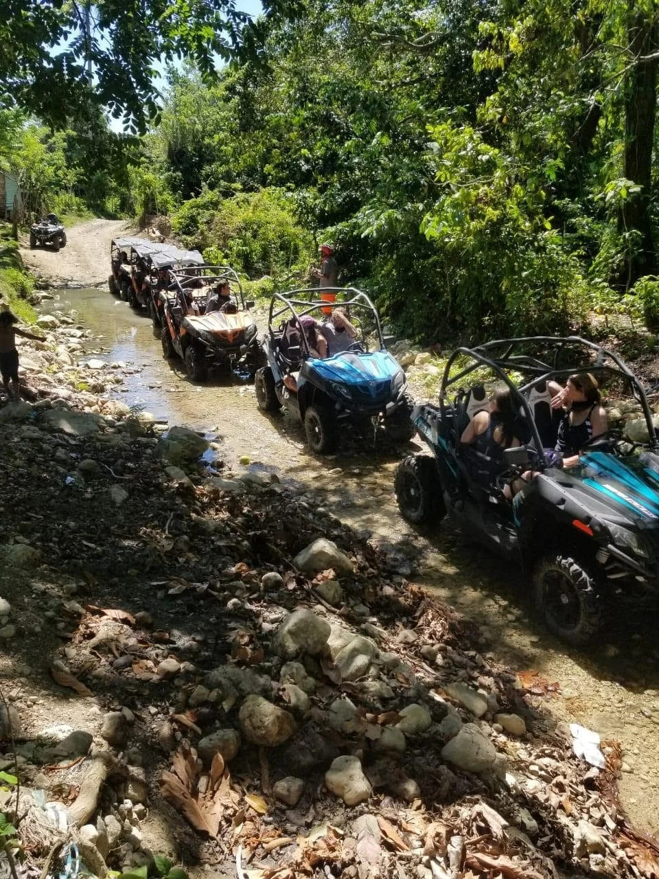 Off-road buggy spraying mud while driving through a rugged trail in Puerto Plata Off-road buggy spraying mud while driving through a rugged trail in Puerto Plata