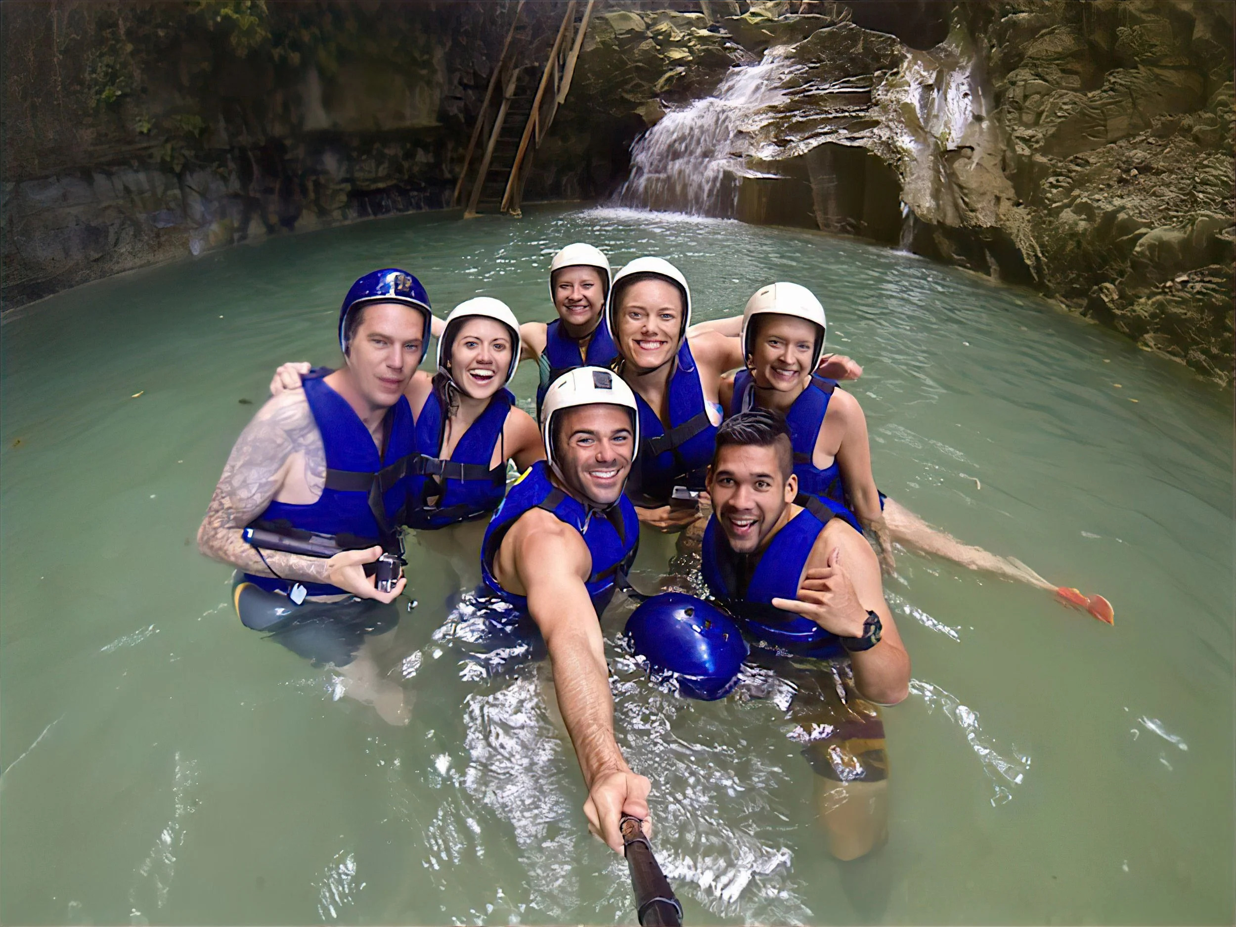 Traveler jumping into a turquoise pool at Damajagua Waterfalls surrounded by Dominican jungle. Traveler jumping into a turquoise pool at Damajagua Waterfalls surrounded by Dominican jungle.