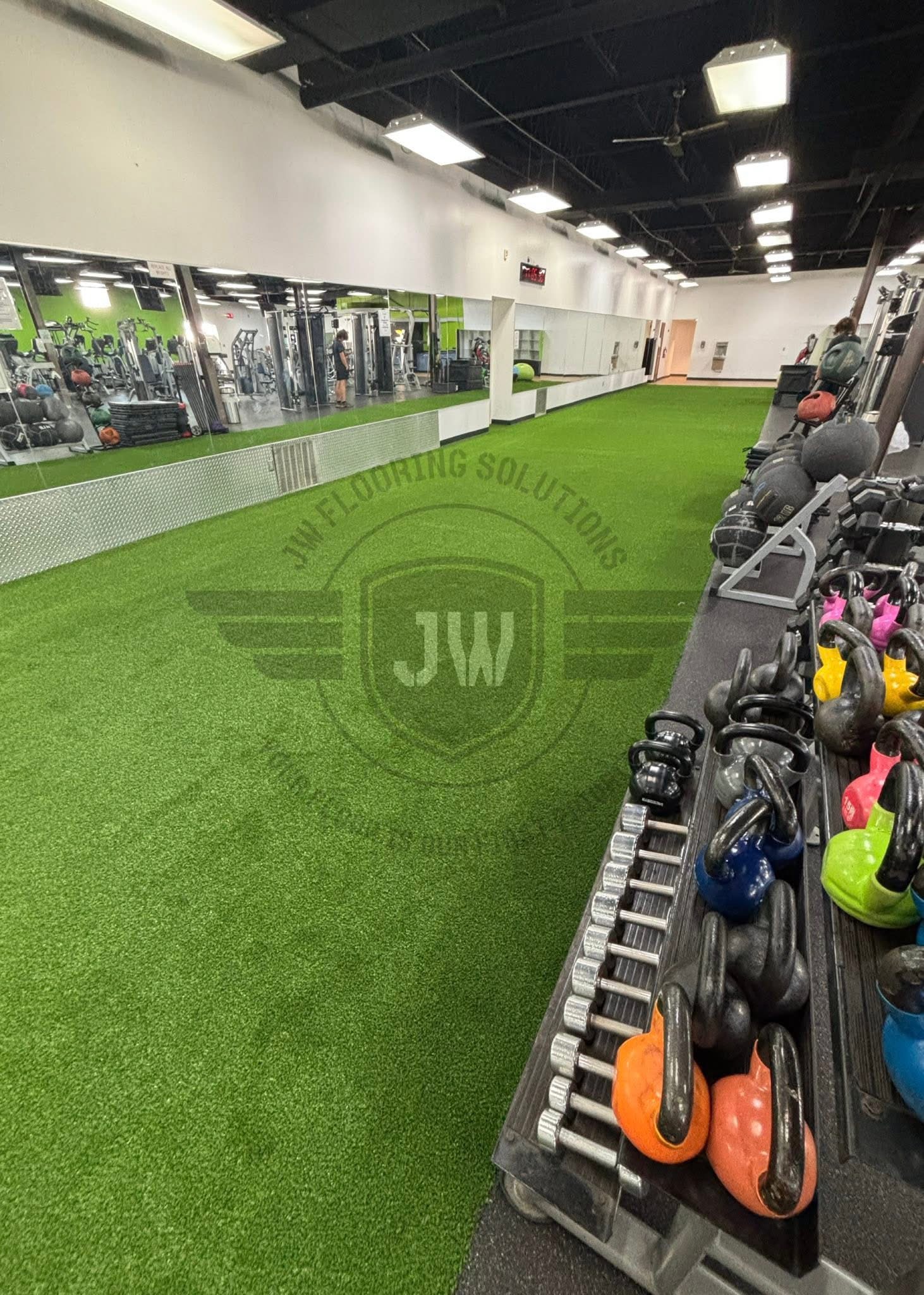 Green indoor turf installation by JW Flooring Solutions