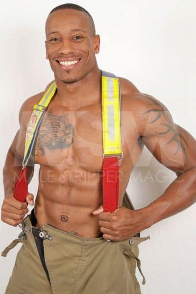 Black male stripper Dante with big smile dressed as firefighter, no shirt