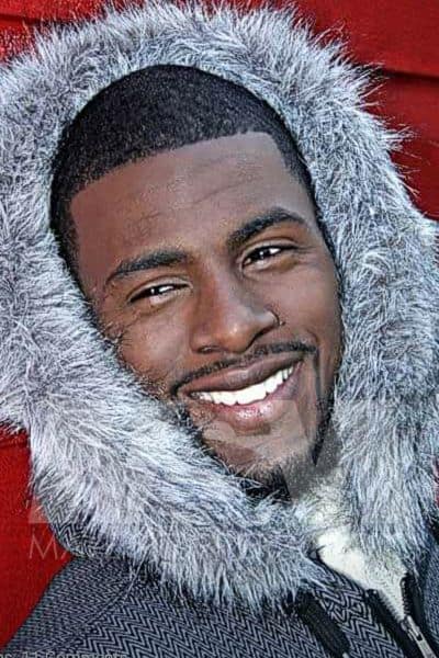 Black male stripper Dream's headshot with big smile and fuzzy winter coat hood