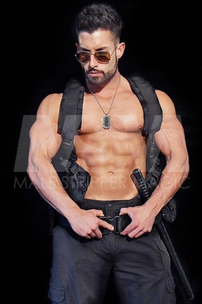 Muscular male stripper Pauley dressed as cop, sunglasses, short beard, SWAT vest, no shirt, police baton and black pants