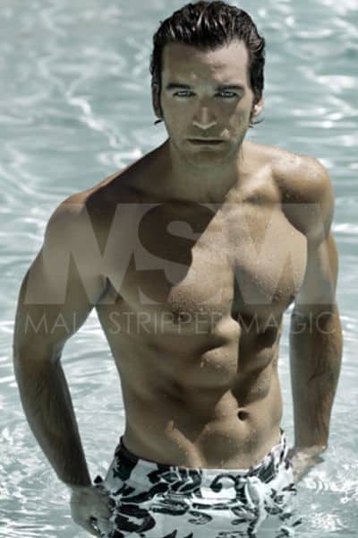 Male stripper Nick, wet, shirtless, swim trunks, emerging from a pool