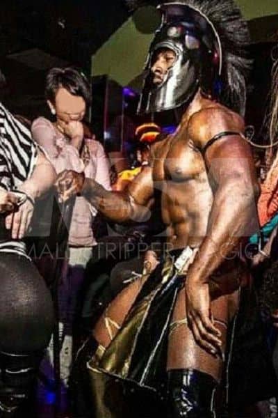 Black male stripper Dream as a Spartan during a male revue