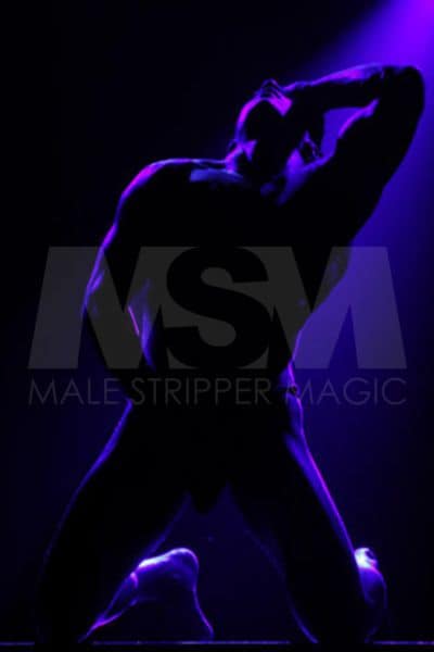 Male stripper Jay performing at a male review in dark lights