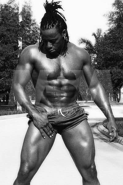 Black male stripper Kingston, trunks, and braids, outside