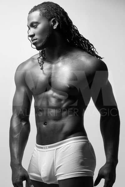 Black male stripper Showtime, black and white photo, wearing Calvin Klein underwear, shirtless, and with braids