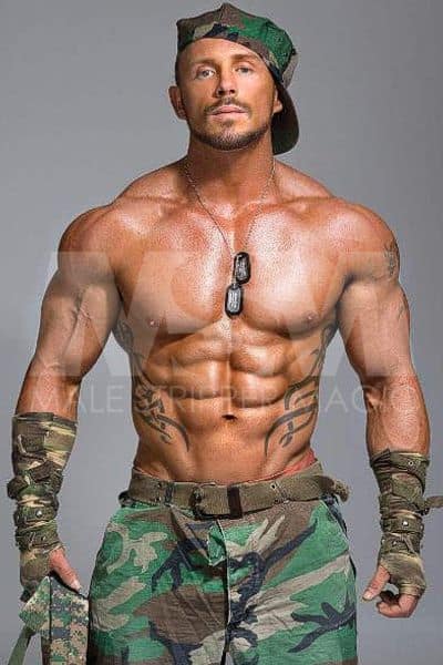 Male stripper Sebastian, shirtless, muscular, wearing camo and dog tags