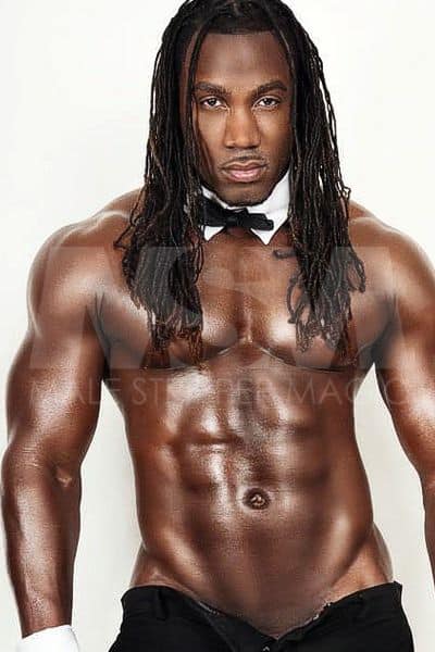 Black male stripper Showtime, shirtless, wearing a bow tie and black pants, Chippendale style