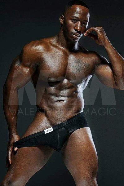 Black male stripper XL showing muscular chest, abs, wearing black underwear