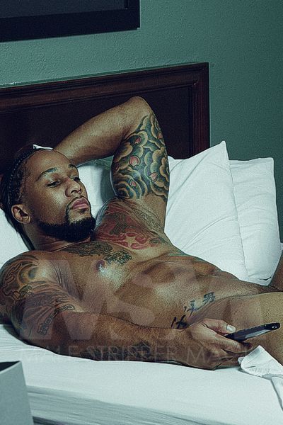 Black male stripper Pleasure lying in bed watching TV