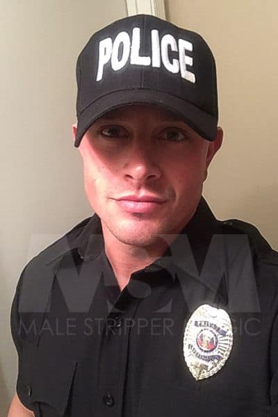 Attractive headshot of male stripper Dean in a police officer costume