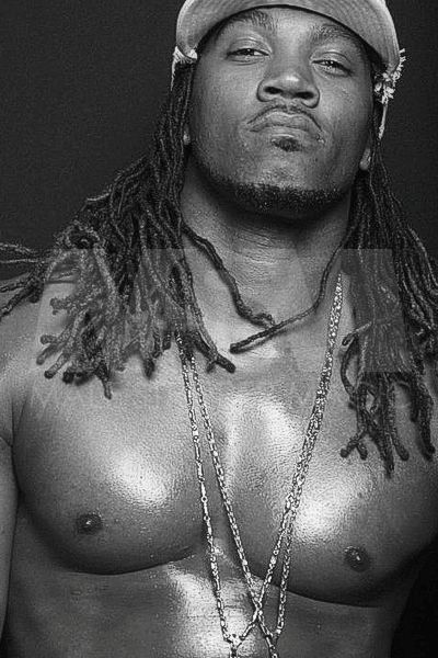 Black male male stripper Showtime exuding confidence with braids and a baseball cap